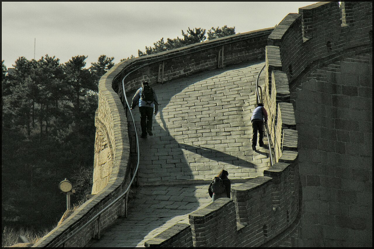 People climbing the steep steps of the Great Wall at Badaling